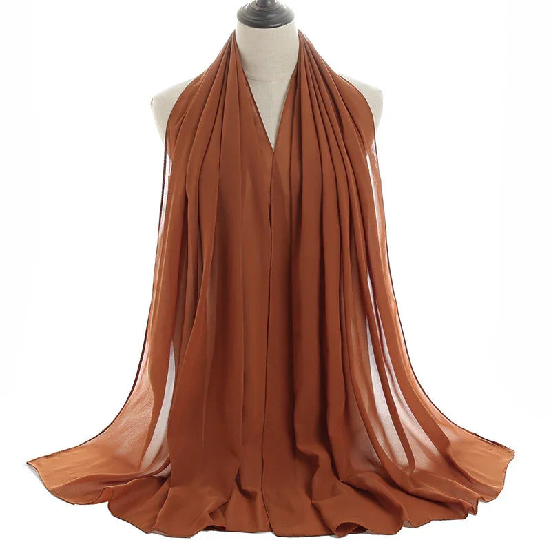 Rust brown chiffon scarf draped on mannequin, lightweight and flowing fabric