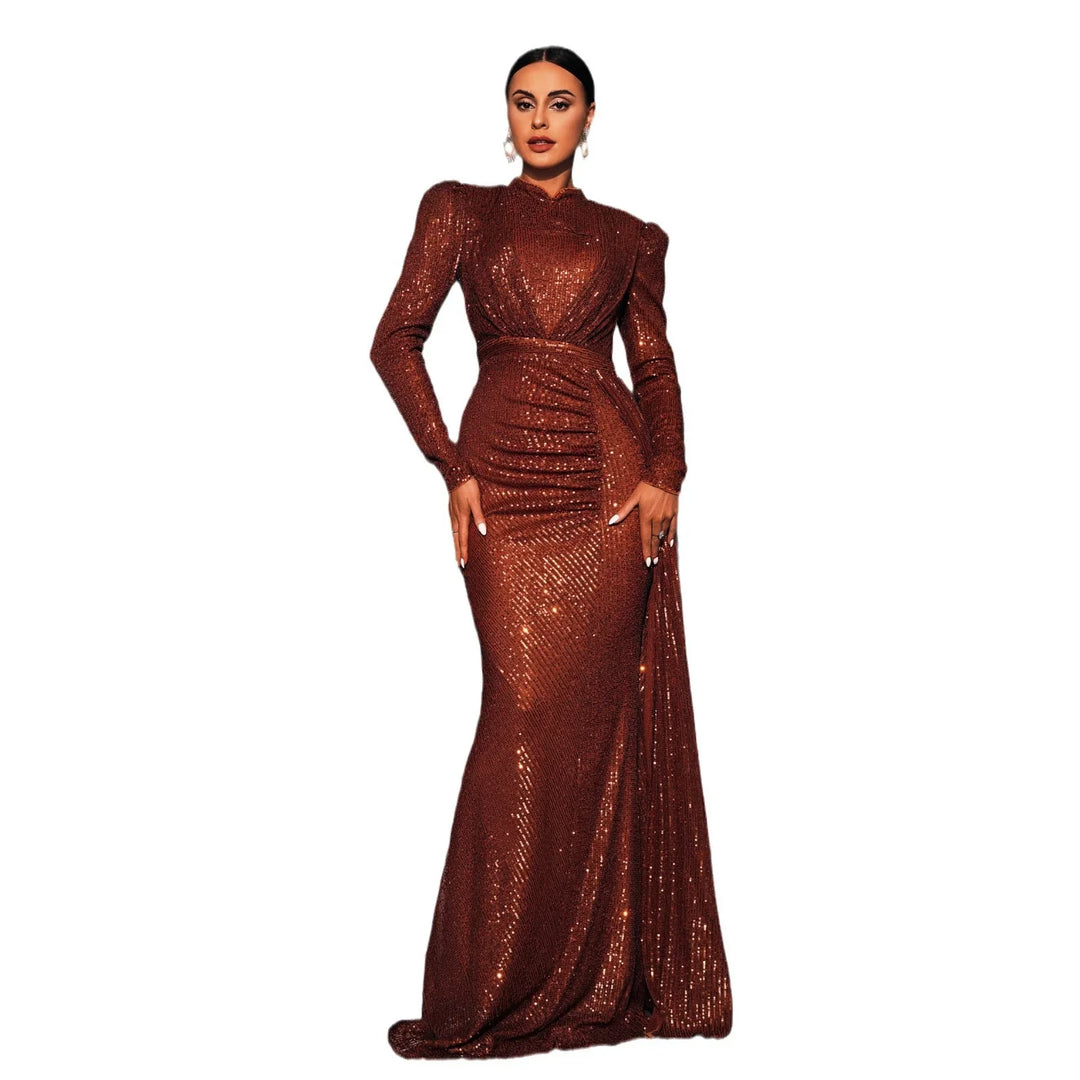 Woman wearing long brown sequin evening gown with long sleeves and structured shoulders