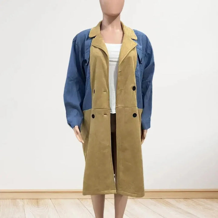 Woman's long coat with blue sleeves and mustard yellow front panels over white top on mannequin