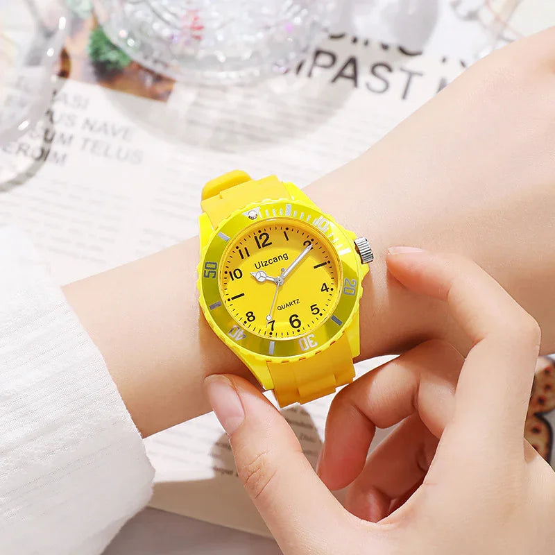 Close-up of a person adjusting a bright yellow Uzcang quartz wristwatch on their arm