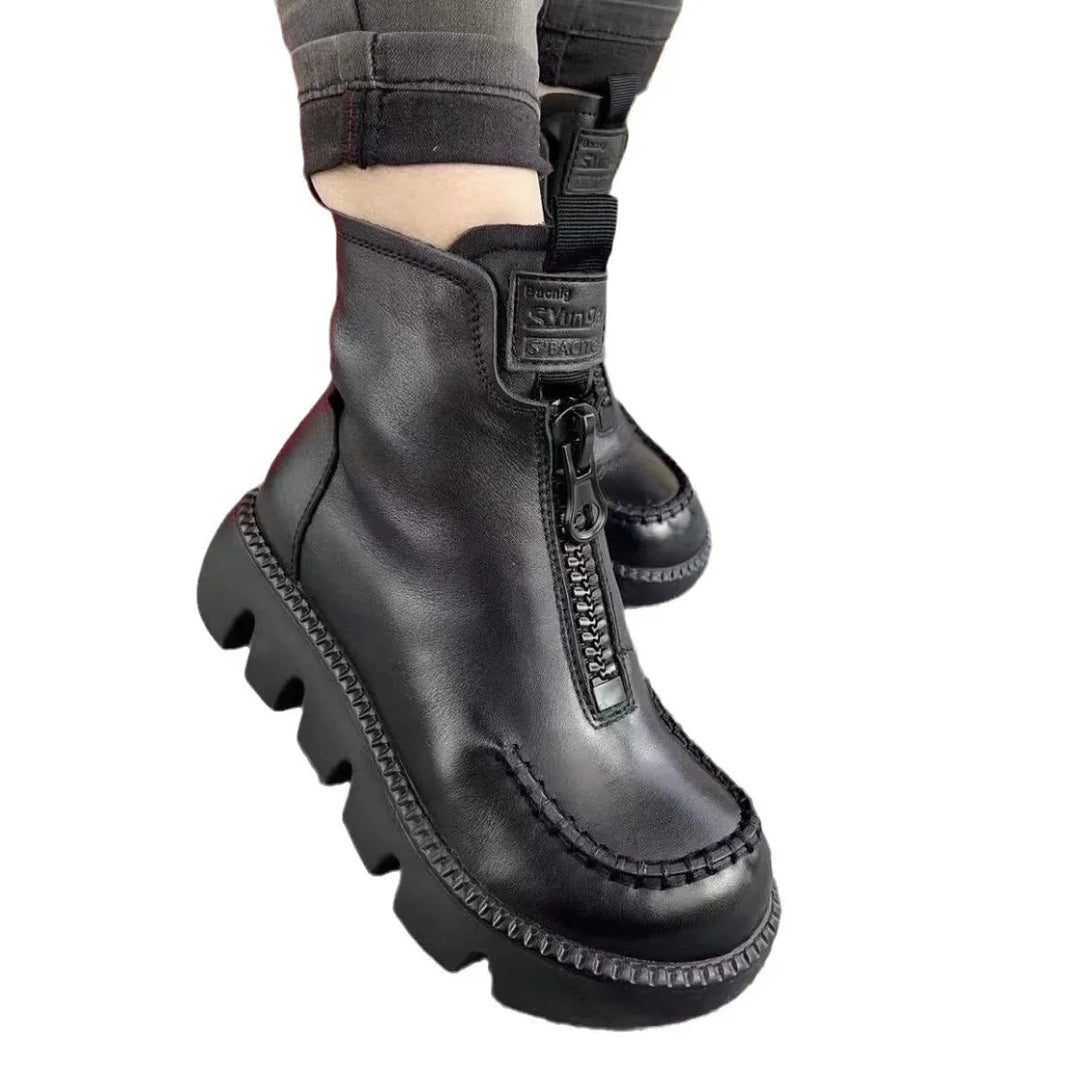 Black leather platform ankle boots with front zipper and chunky ridged soles