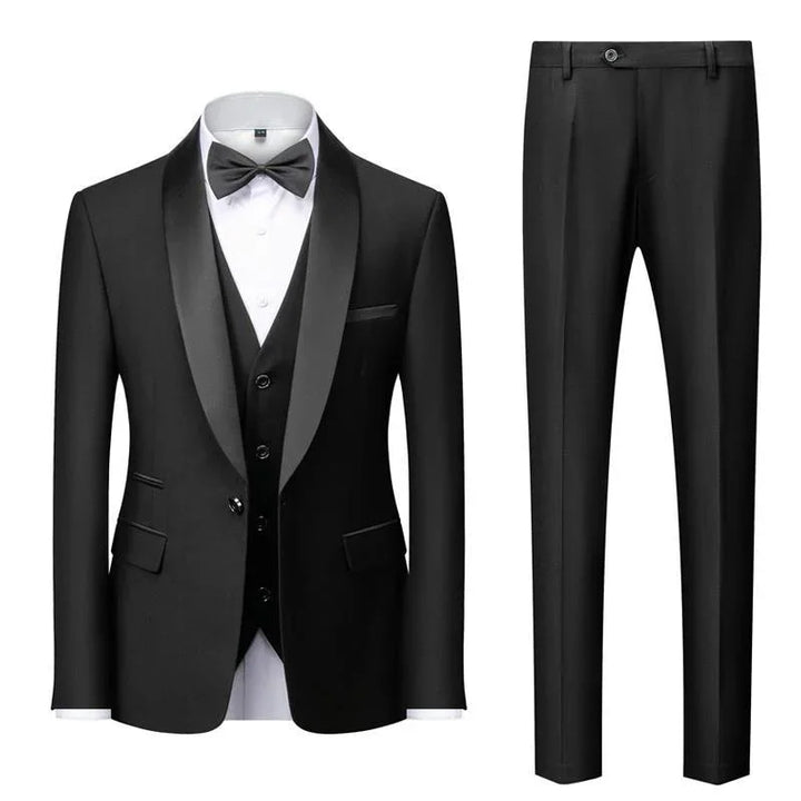 Black tuxedo suit with satin lapel, white dress shirt, black bow tie, vest, and matching black pants