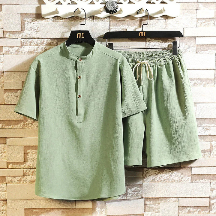Light green men's casual short sleeve shirt with button placket and matching elastic waist shorts on hangers