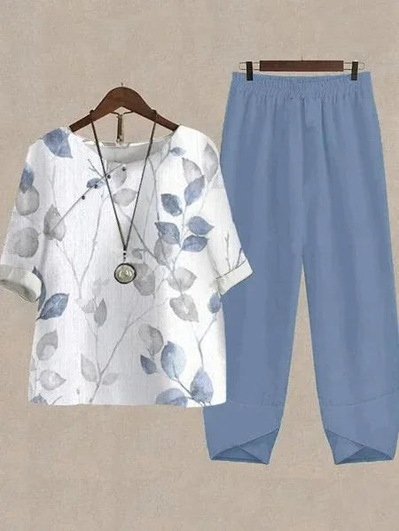 Women's casual outfit with white floral print blouse and light blue elastic waist pants