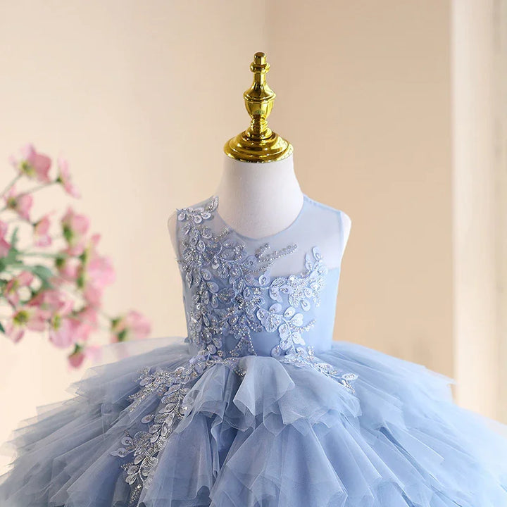 Elegant light blue girl's party dress with floral lace and layered tulle skirt on mannequin