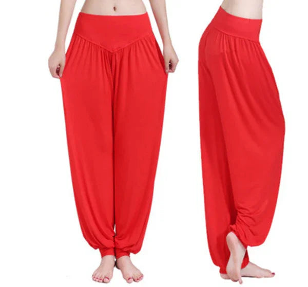 woman wearing bright red wide-leg harem pants with gathered ankles against white background