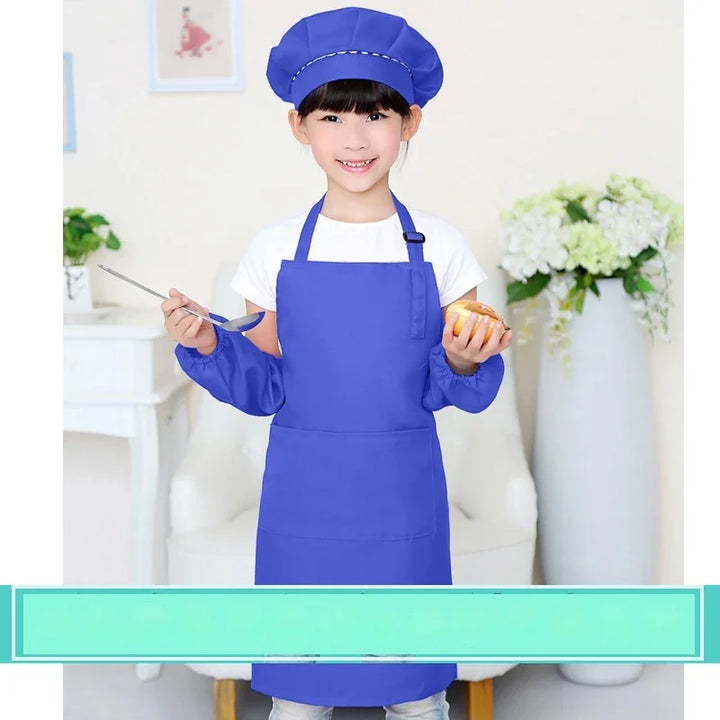 Smiling girl wearing blue chef hat and apron holding a spoon and bread in a kitchen setting