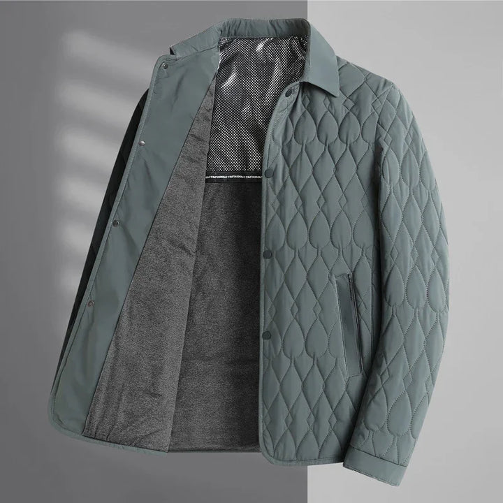 Green quilted jacket with diamond and teardrop stitching, gray inner lining, and snap button closure