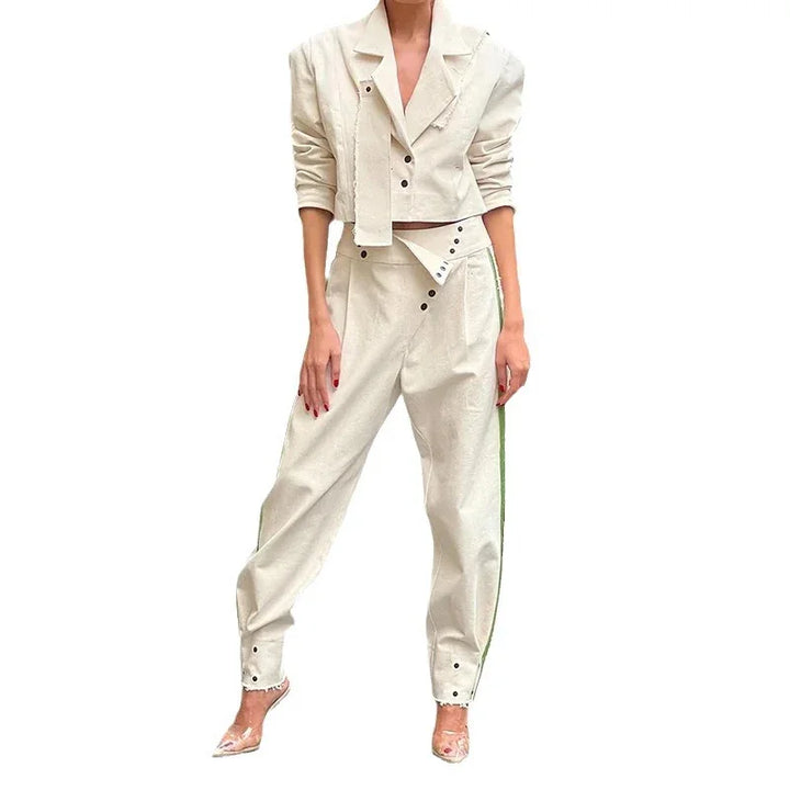 woman wearing stylish cream-colored cropped jacket and high-waisted trousers with button details