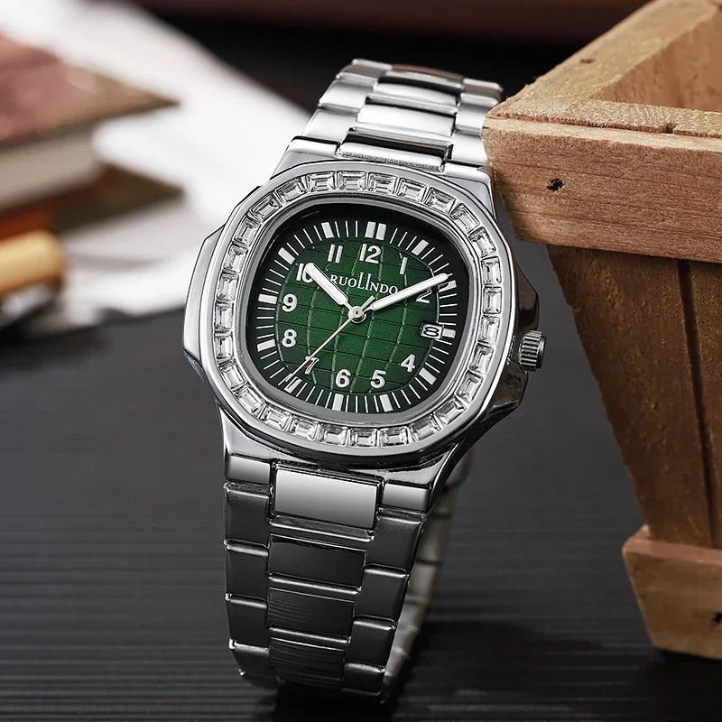 Silver stainless steel wristwatch with green checkered dial and date display on black surface