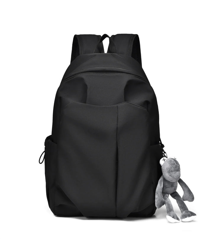 Black backpack with front pocket and plush gray frog keychain accessory