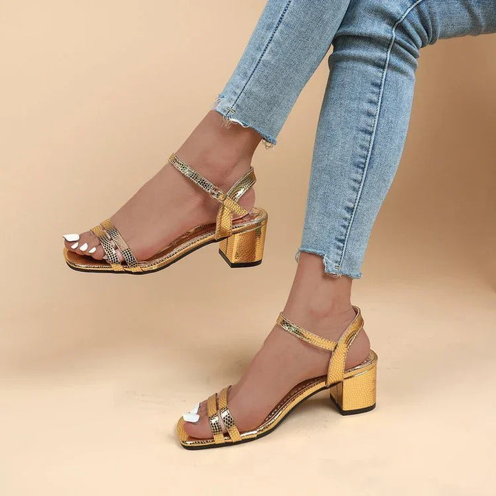 Gold block heel sandals with ankle straps worn with light blue frayed hem jeans