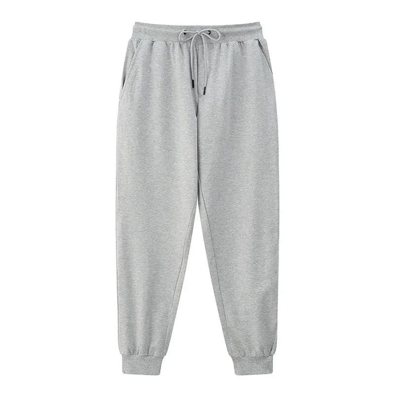 Light grey casual sweatpants with elastic waistband, drawstring, side pockets, and cuffed ankles