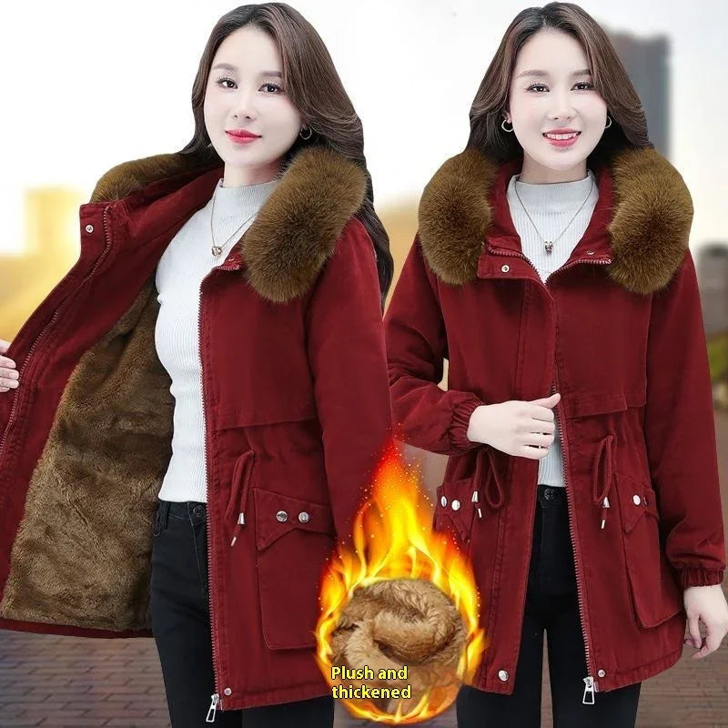 Woman wearing red winter coat with plush fur lining and thickened collar, showcasing warmth features