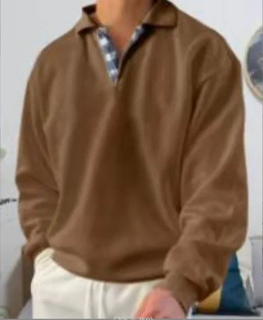 man wearing brown long-sleeve polo shirt with checkered collar detail and white pants indoors
