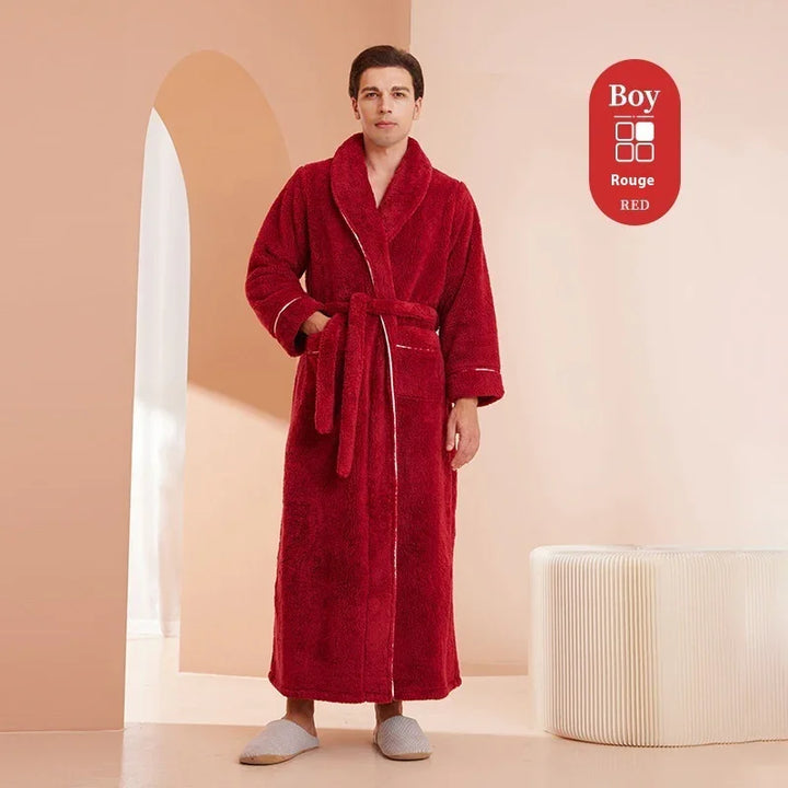 Man wearing long red plush robe with belt and pockets standing indoors by archway and modern ottoman
