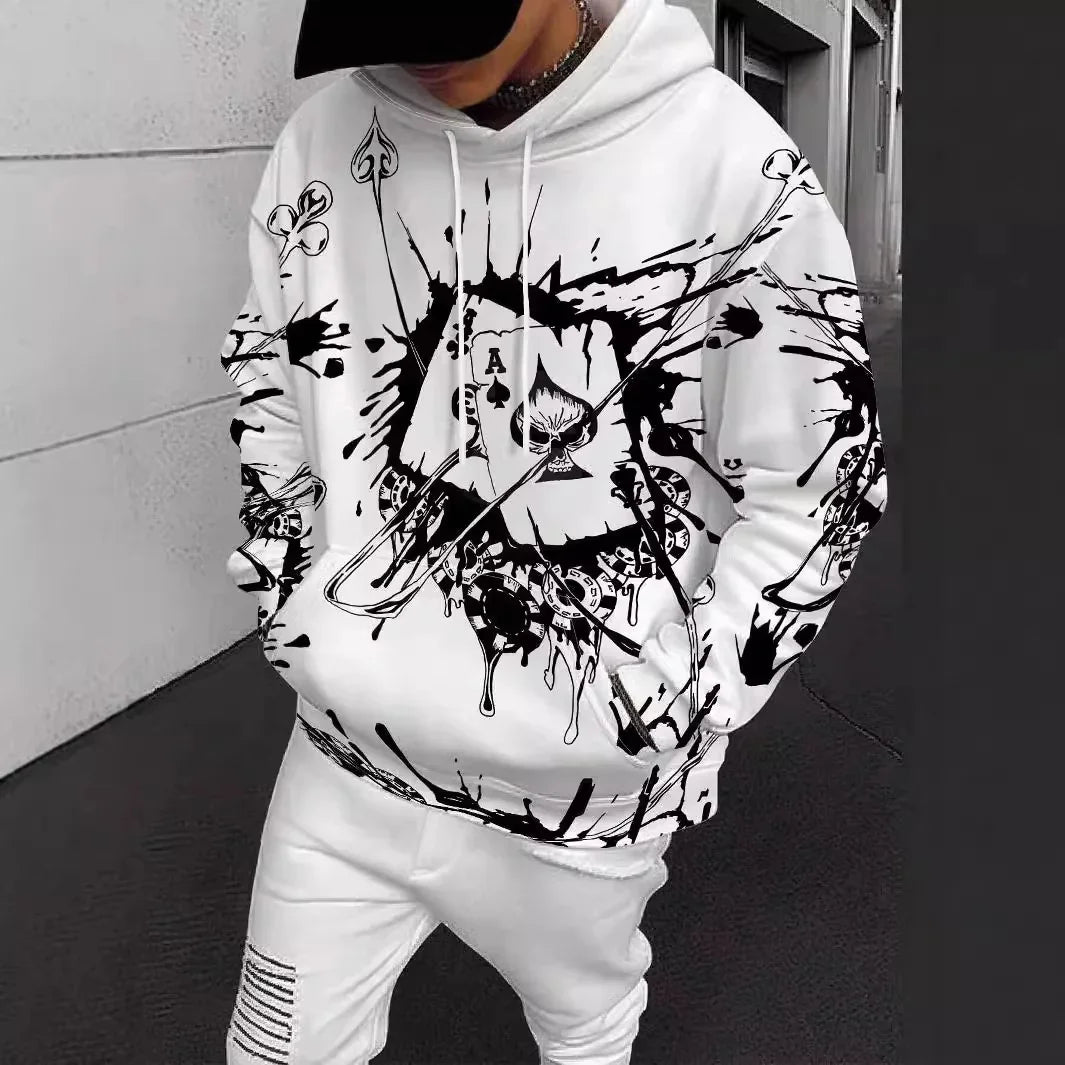 Person wearing white hoodie with black ace of spades skull and abstract graphic design, paired with white pants