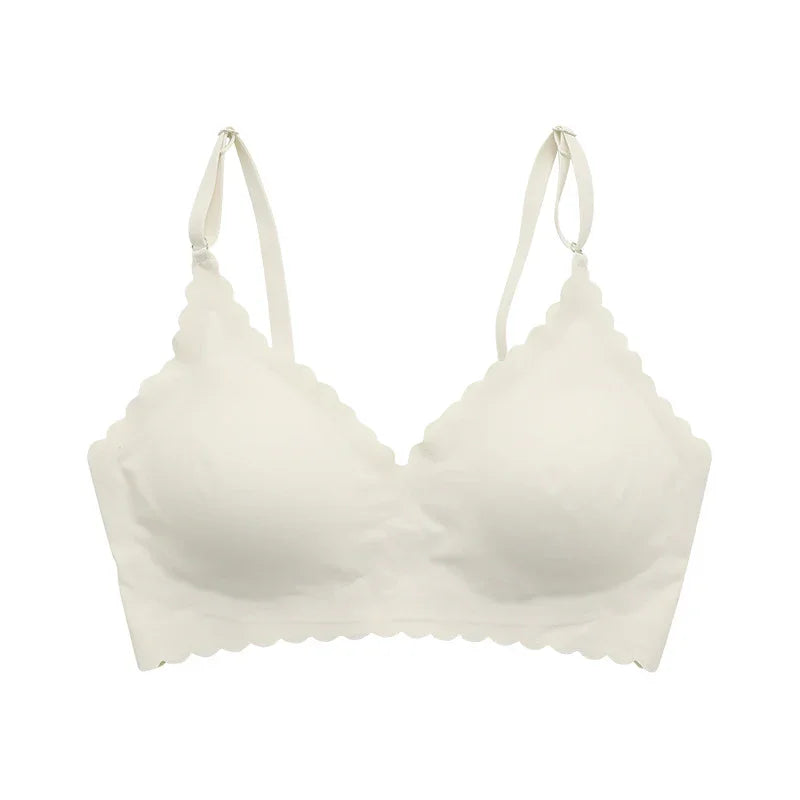 White scalloped edge wireless bra with adjustable straps on white background