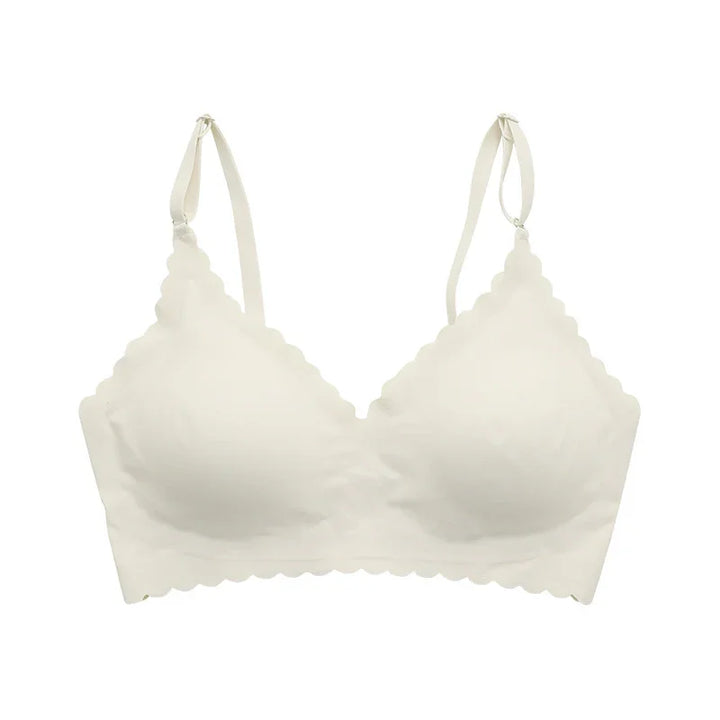 White scalloped edge wireless bra with adjustable straps on white background