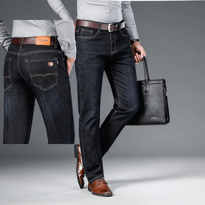 Men's dark blue denim jeans with brown belt, brown leather shoes, and black leather briefcase