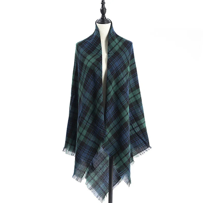 Blue and green plaid wool shawl with fringe edges displayed on a dress form