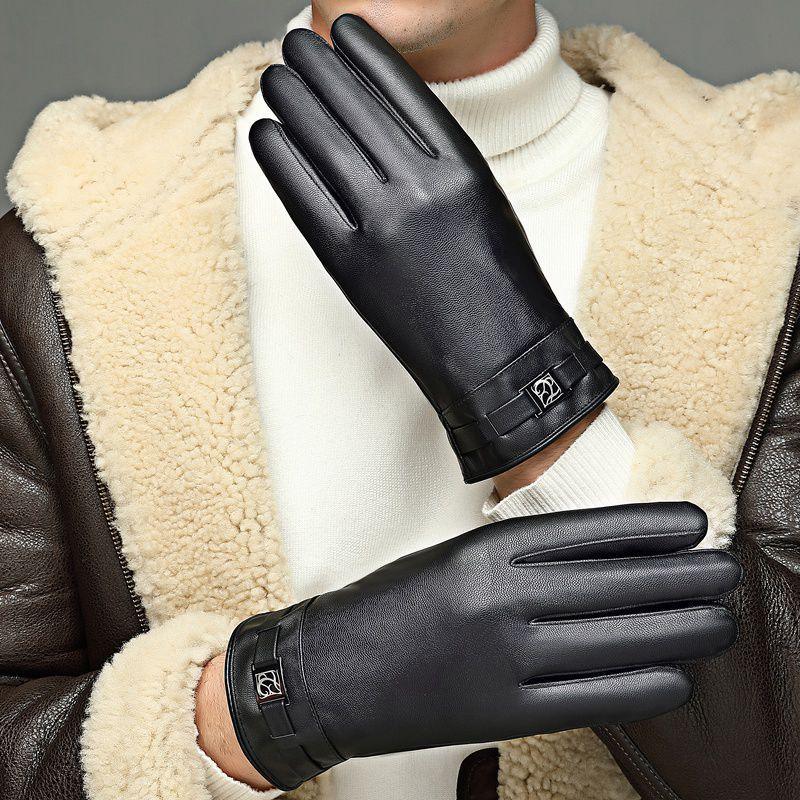 man wearing black leather winter gloves with buckle detail and shearling jacket