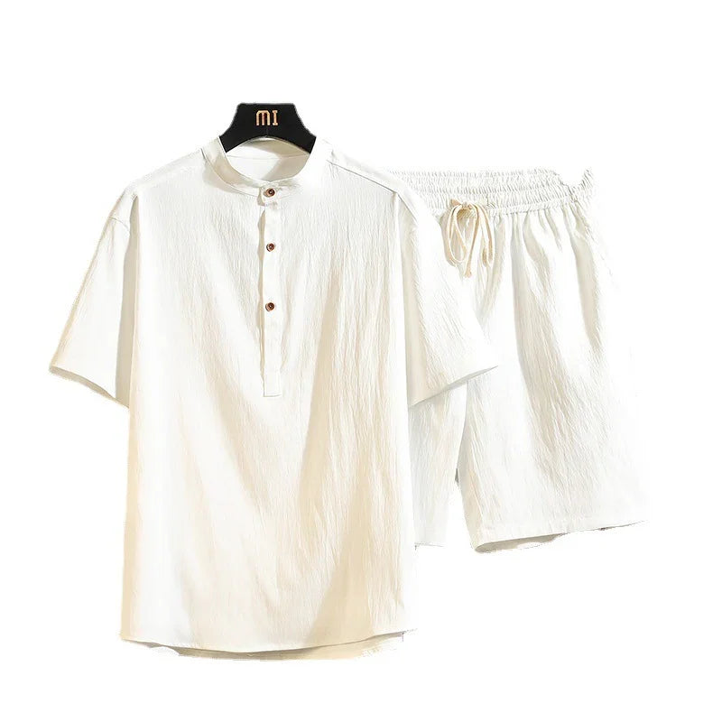 White lightweight men's summer outfit with short sleeve shirt and elastic waist shorts on white background