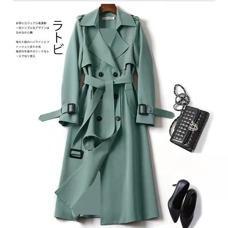 Stylish green trench coat with belt paired with black quilted handbag and black high heels
