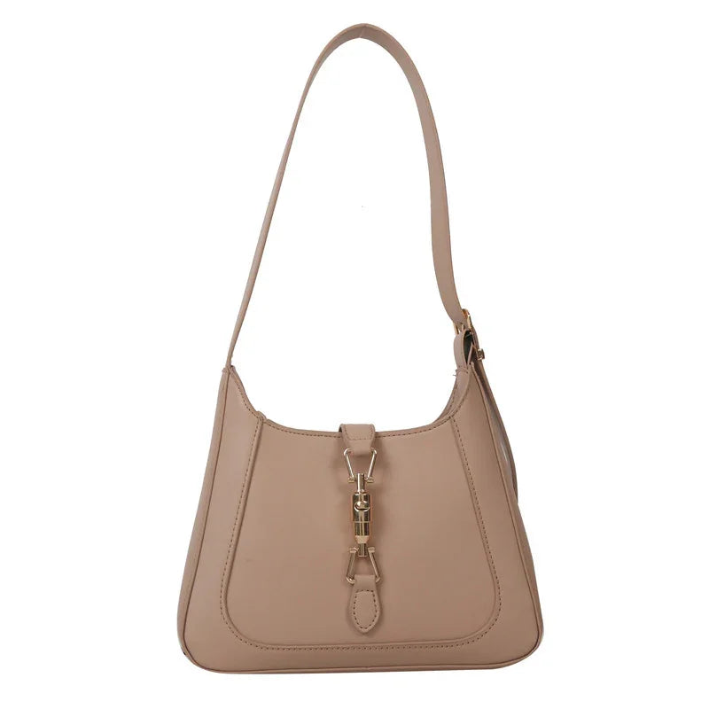 Beige leather shoulder bag with gold-tone clasp and structured silhouette