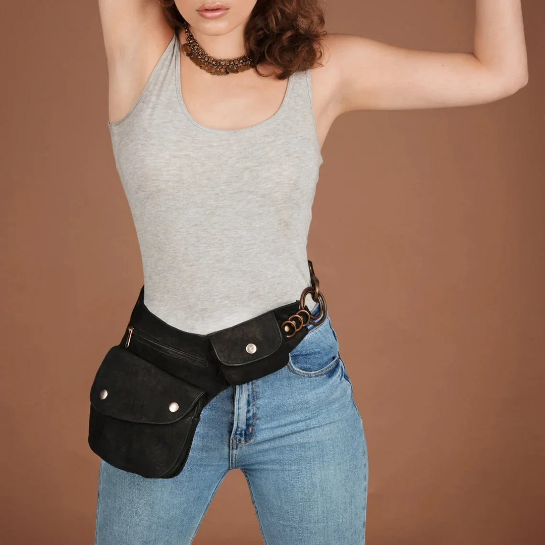 Woman wearing gray tank top and jeans with black leather hip bag and decorative belt accessory
