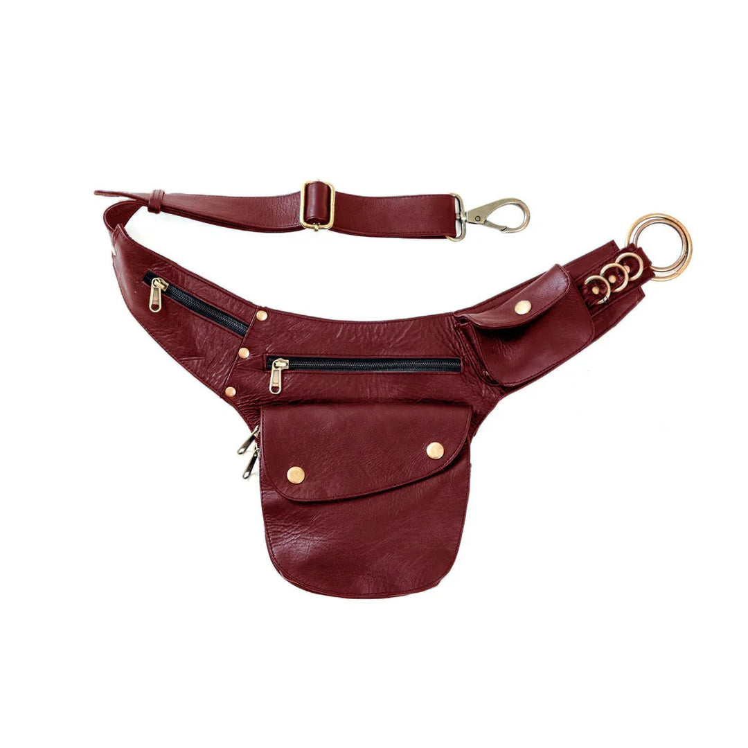 Maroon leather waist bag with gold hardware, multiple zippered pockets, and adjustable strap