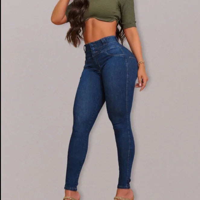 woman wearing high-waisted skinny blue jeans and olive green cropped top on gray background