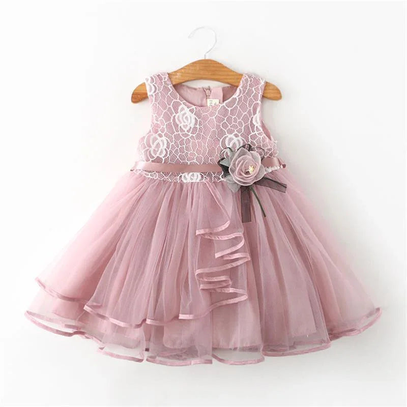 Pink sleeveless toddler dress with white lace floral bodice and tulle skirt featuring a pink and gray flower embellishment