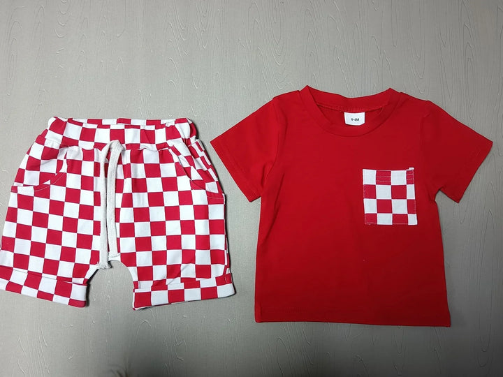 Red baby t-shirt with checkered red and white pocket and matching checkered shorts laid flat