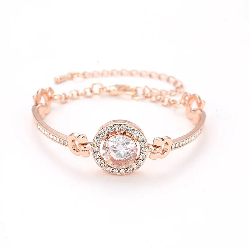rose gold bracelet with central round clear crystal and small crystals on chain links