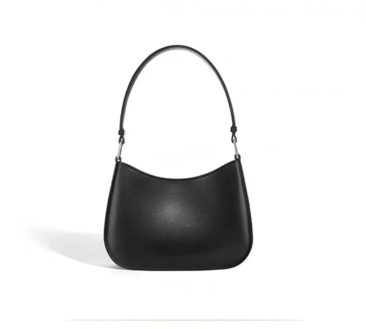Black leather shoulder bag with curved bottom and single strap on white background