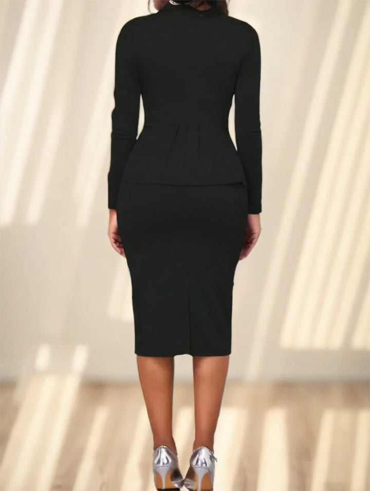 Back view of woman wearing fitted black long-sleeve dress with silver high heels on wooden floor