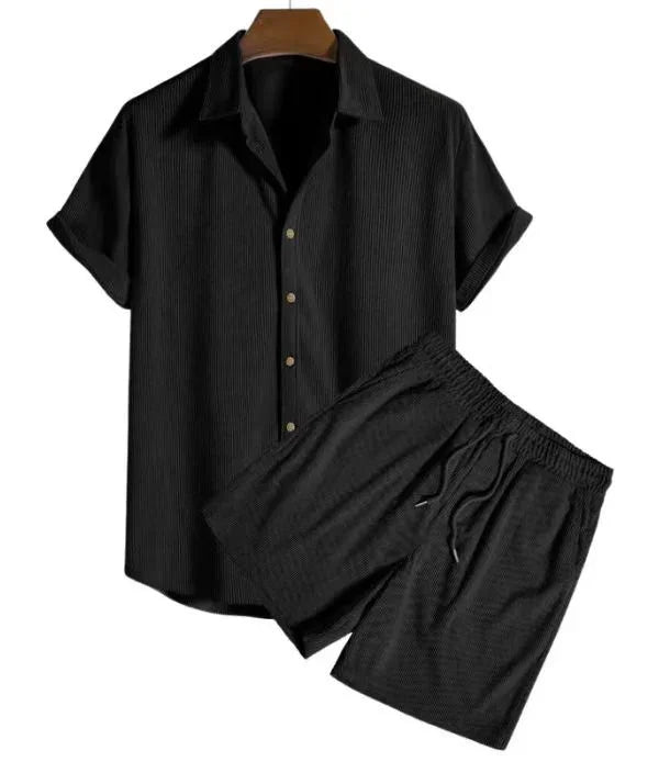 Black short sleeve button-up shirt and matching elastic waist shorts set on hanger