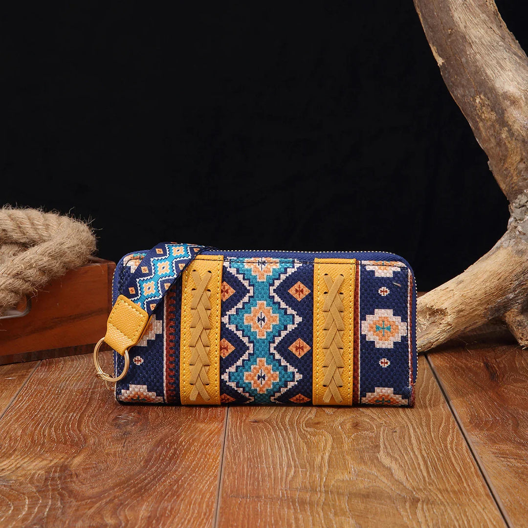 Colorful patterned zippered wallet with blue, turquoise, and mustard woven fabric on wooden surface