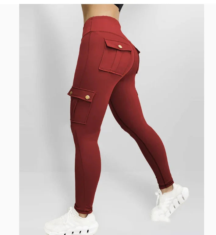 Woman wearing high-waisted burgundy cargo leggings with buttoned flap pockets, paired with white sneakers