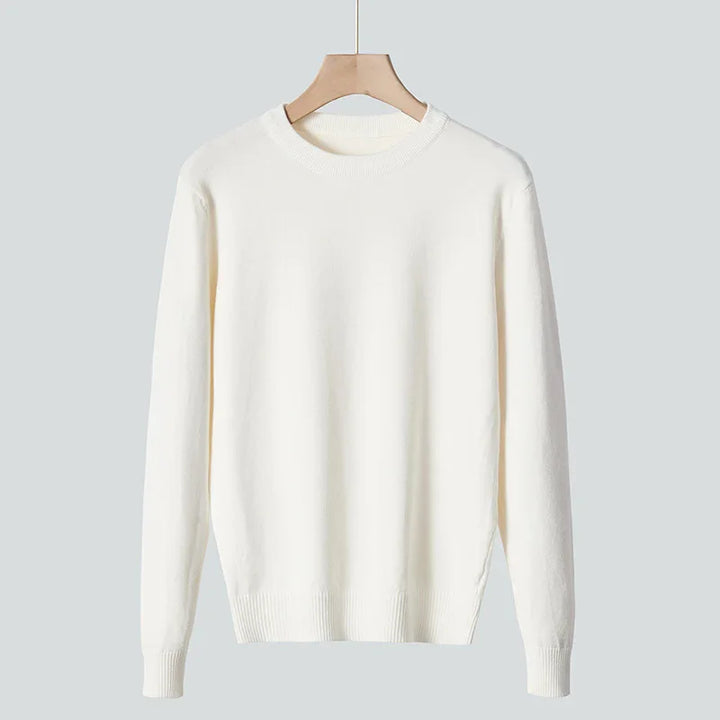 Minimalist white long-sleeve crew neck sweater on wooden hanger against gray background