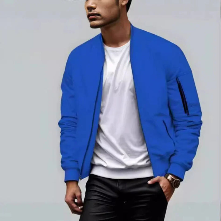 Man wearing a stylish blue bomber jacket with a white t-shirt and black pants, casual fashion