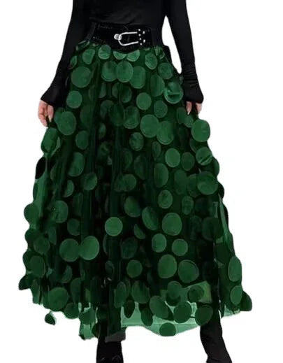 Dark green tulle skirt with large circular appliques paired with black long-sleeve top and belt