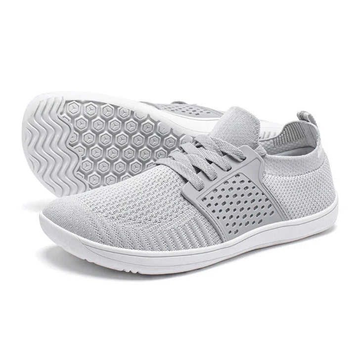 light gray knit fabric casual sneakers with perforated side panels and white patterned rubber soles