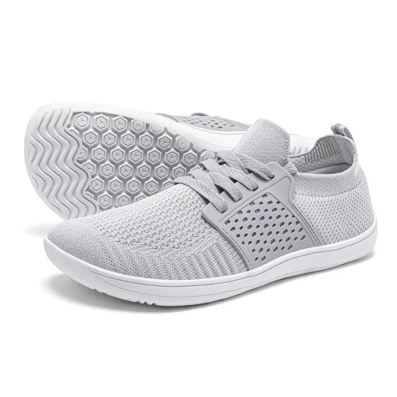 Light gray breathable knit sneakers with white soles and hexagon-patterned outsoles