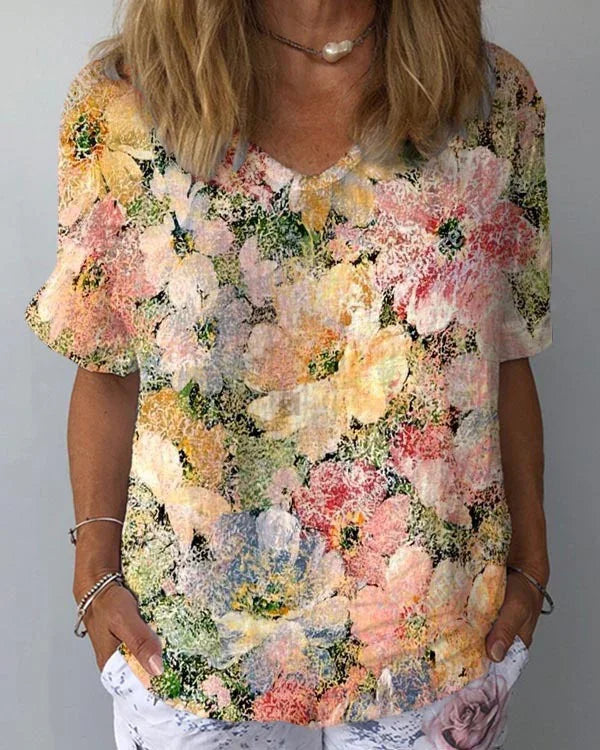 woman wearing colorful floral print short sleeve shirt with mixed pastel flowers