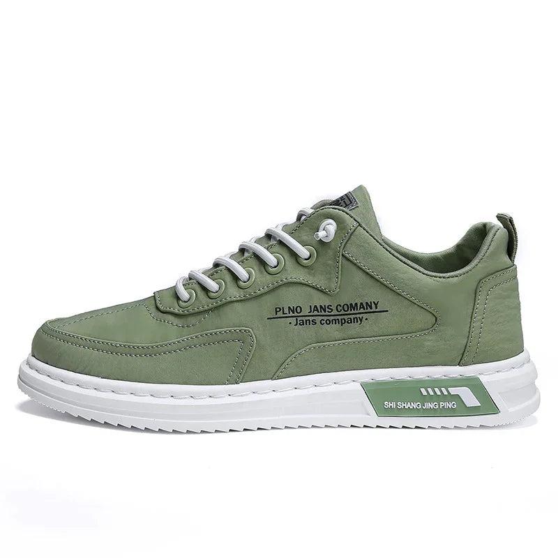 Green casual sneaker with white sole, white laces, and branding text on side and sole