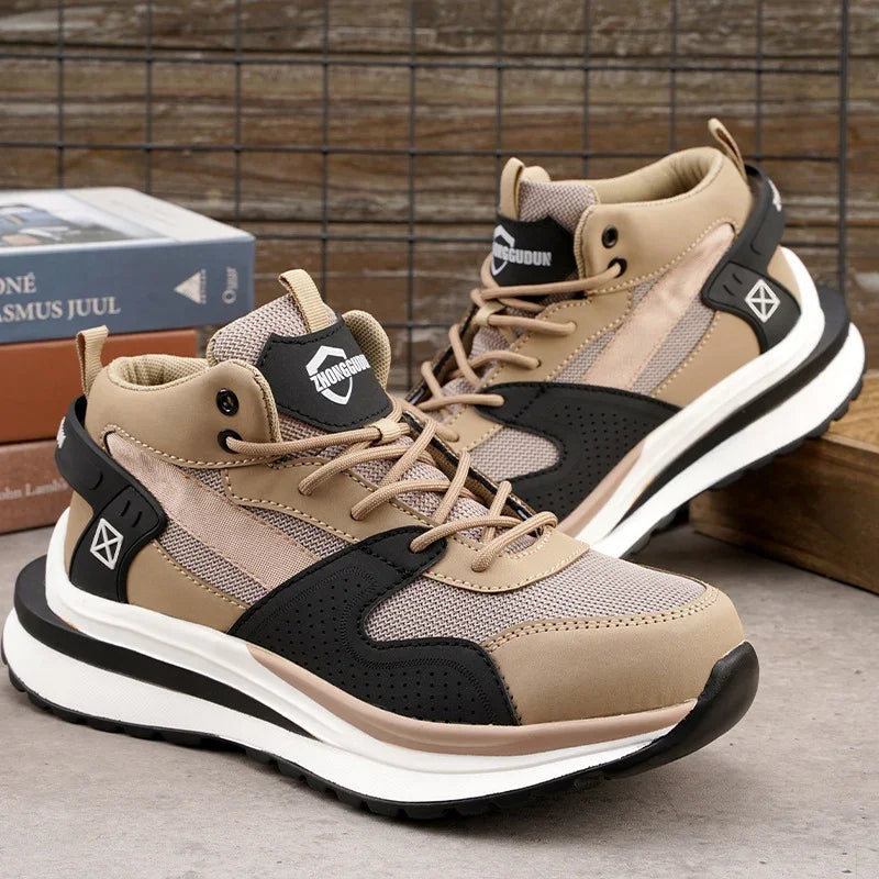 Beige and black athletic sneakers with mesh and synthetic material, placed on concrete with wooden background