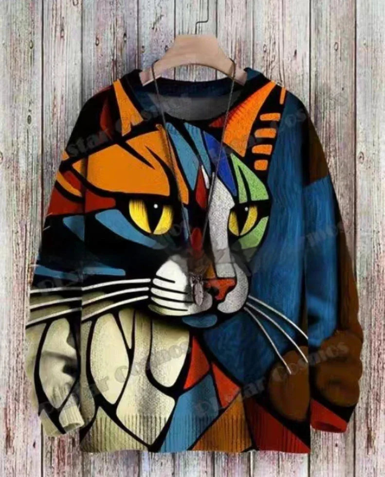 Colorful abstract cat face design printed on a long-sleeve sweatshirt hanging on a wooden background