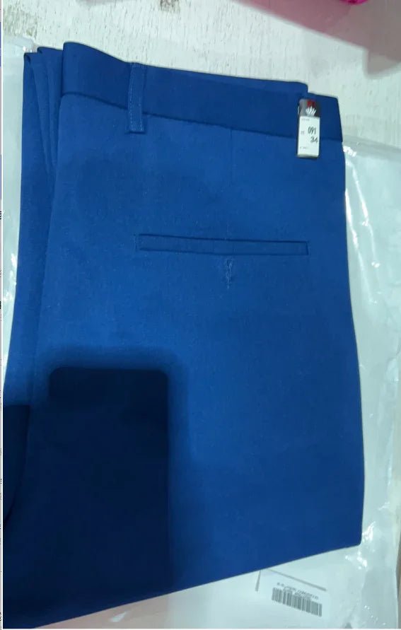 Folded blue formal trousers with single back pocket and size tag on white surface